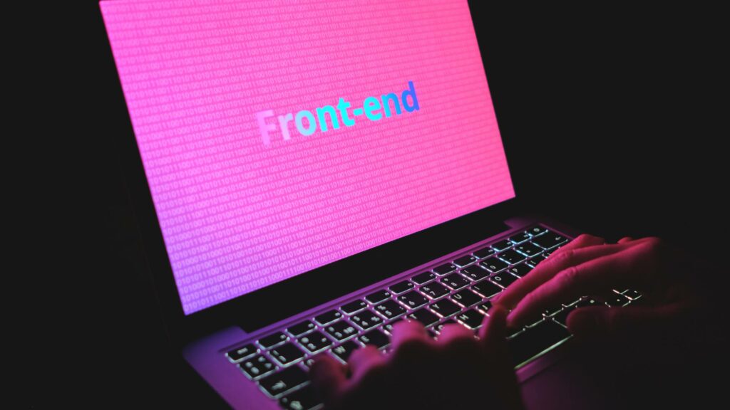 A laptop displays a pink screen with the words Front End displayed.