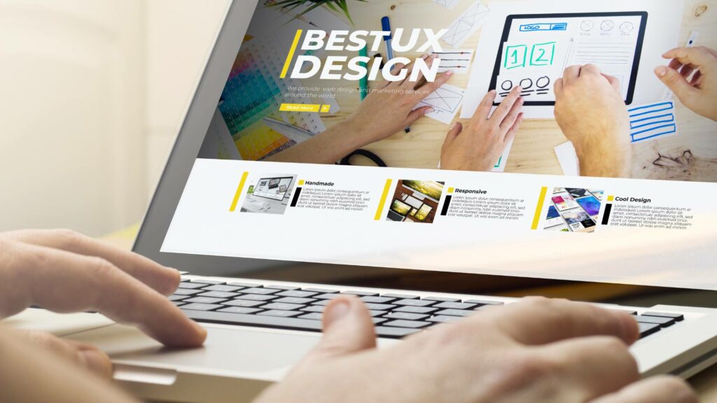 A laptop is displayed with the words BEST UX DESIGN on the screen.