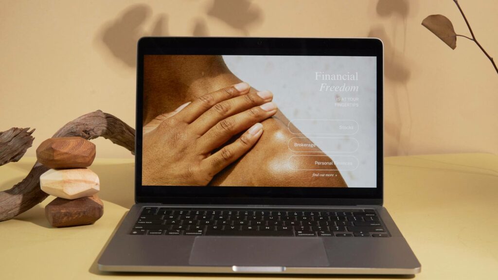 A website homepage is displayed on a laptop with earth tone colors.